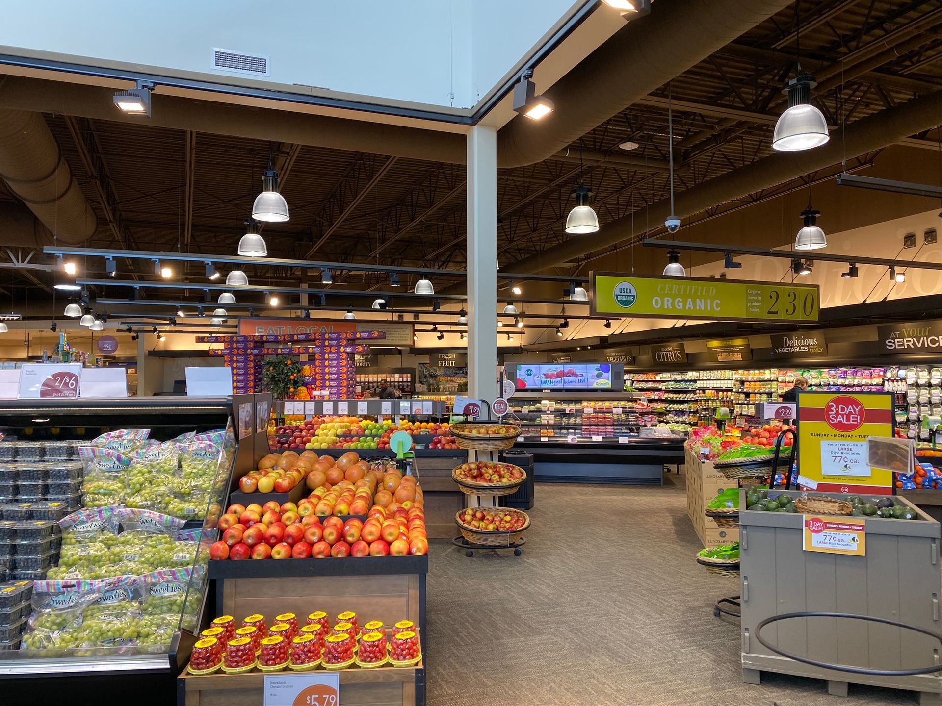 The inside of a grocery store filled with fruits and vegetables.