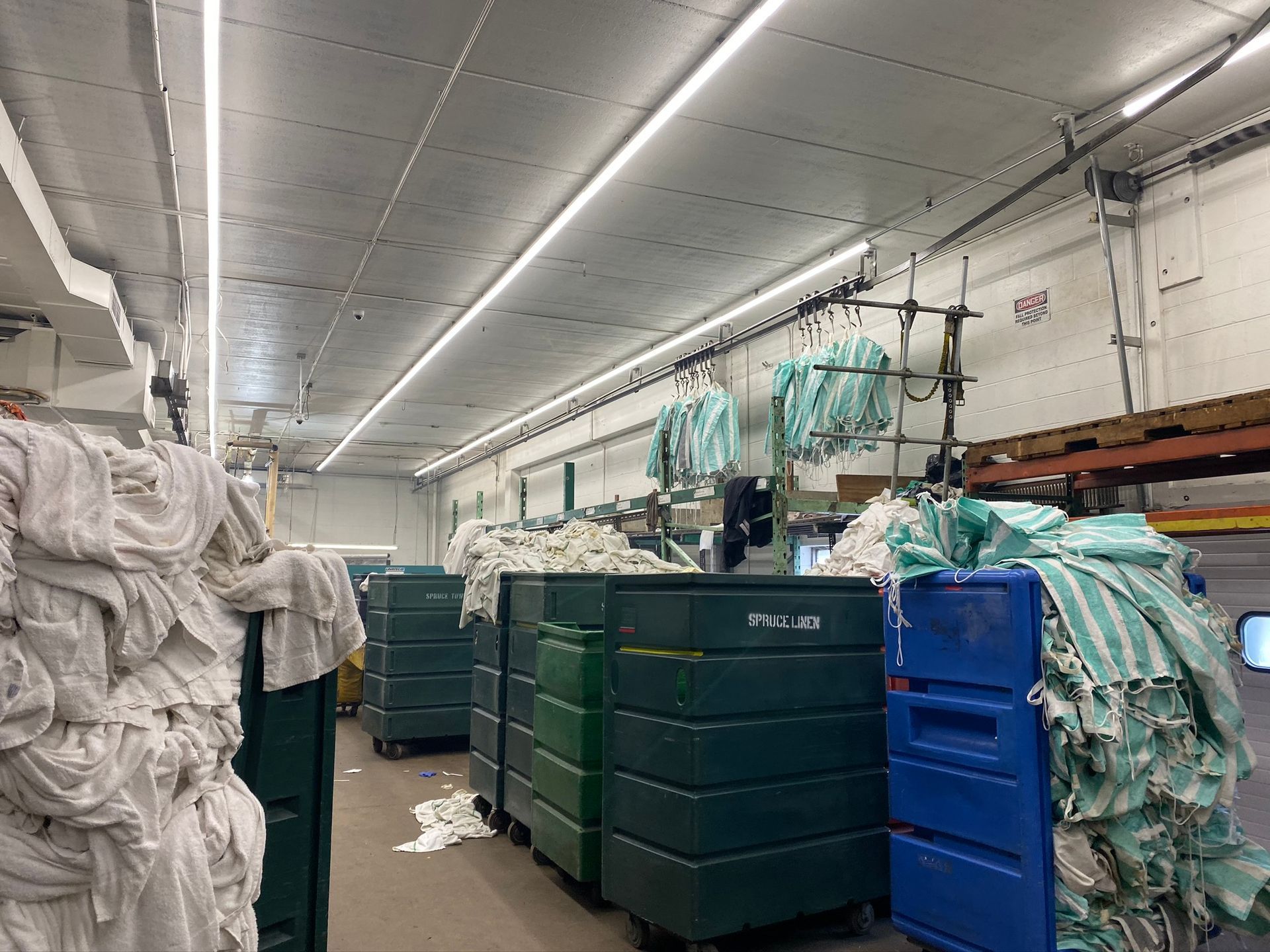 A warehouse filled with lots of clothes hanging on racks.