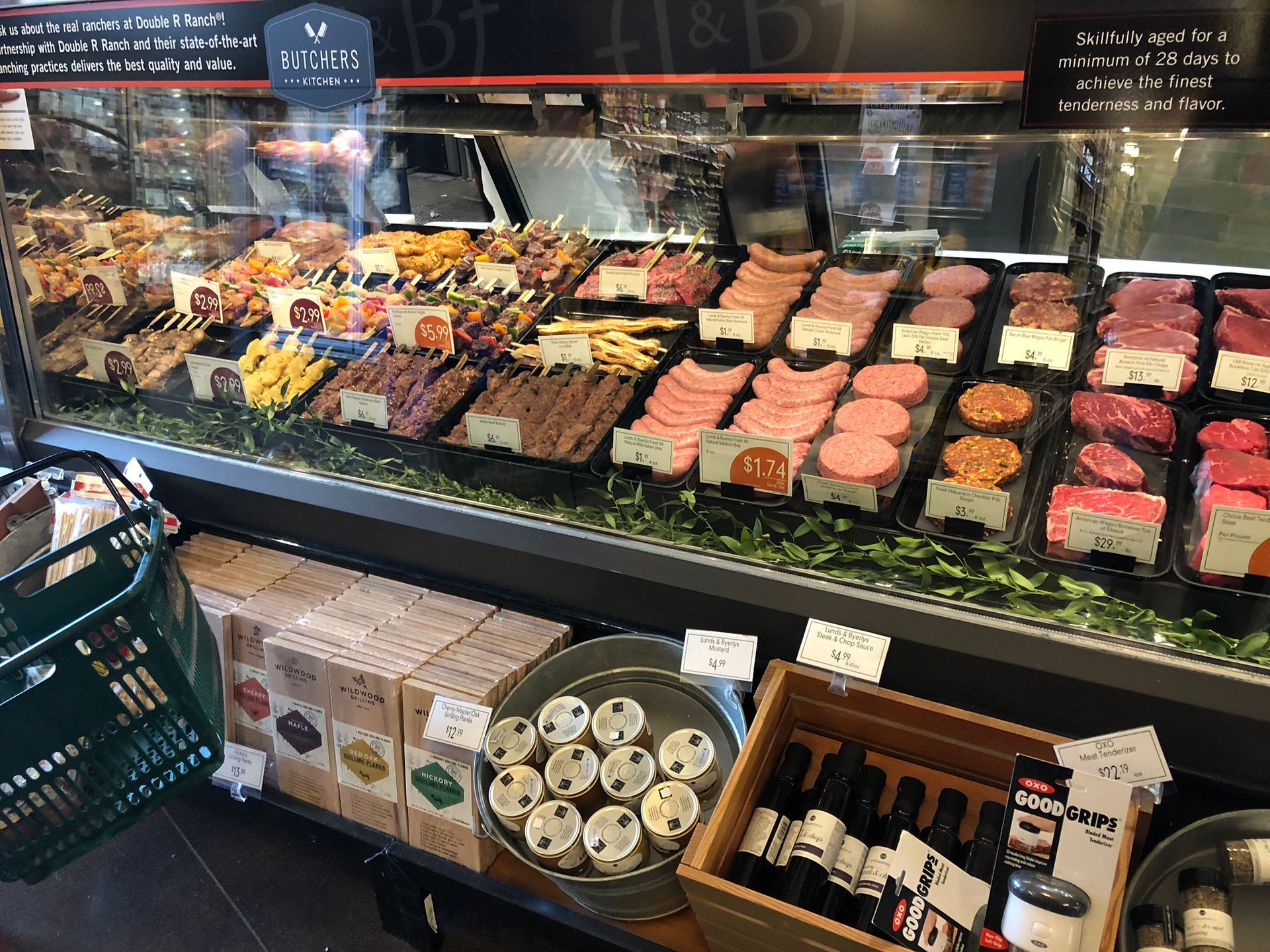 A grocery store display case filled with lots of meats and vegetables.