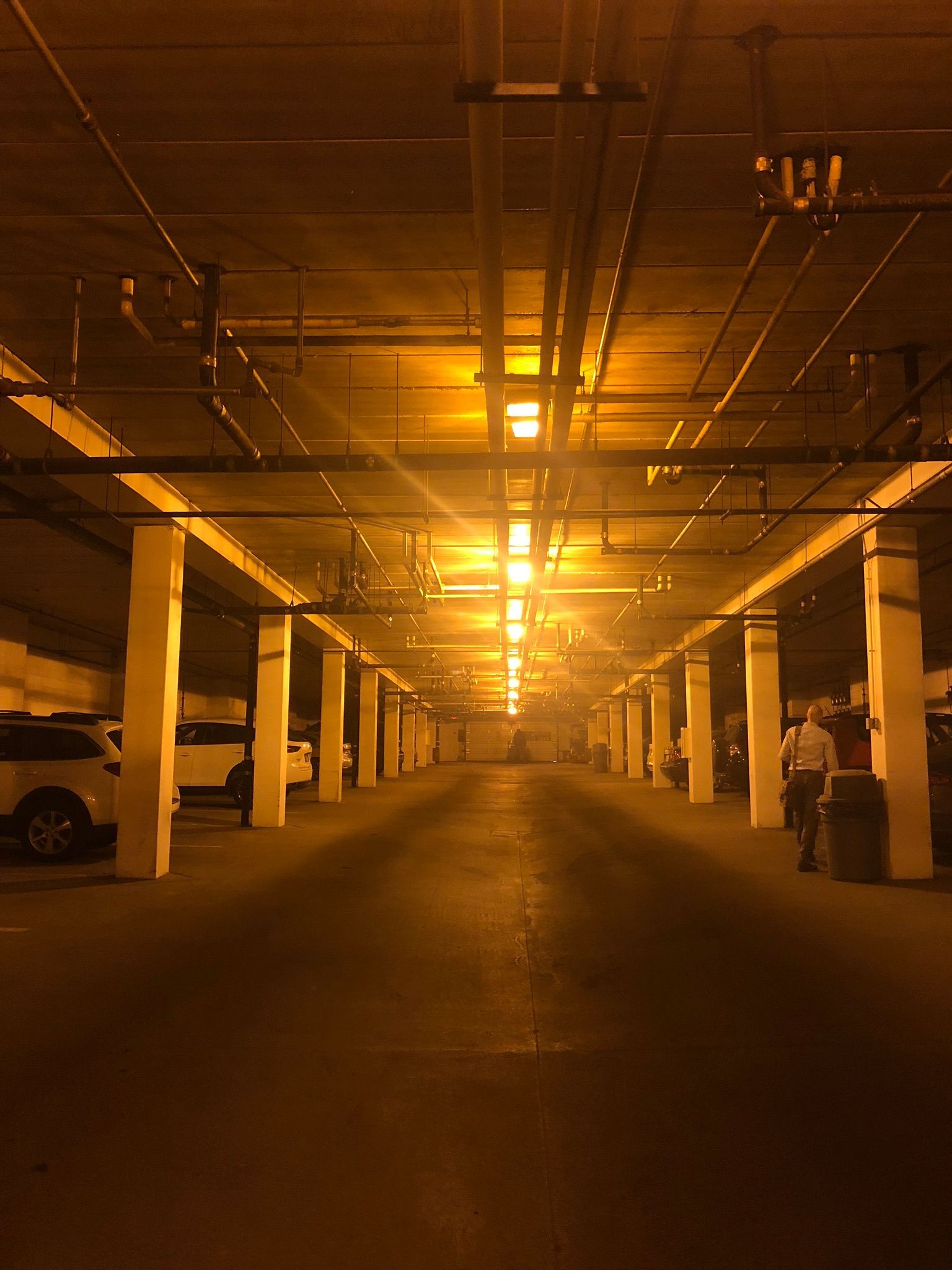 A parking garage with a lot of cars parked in it