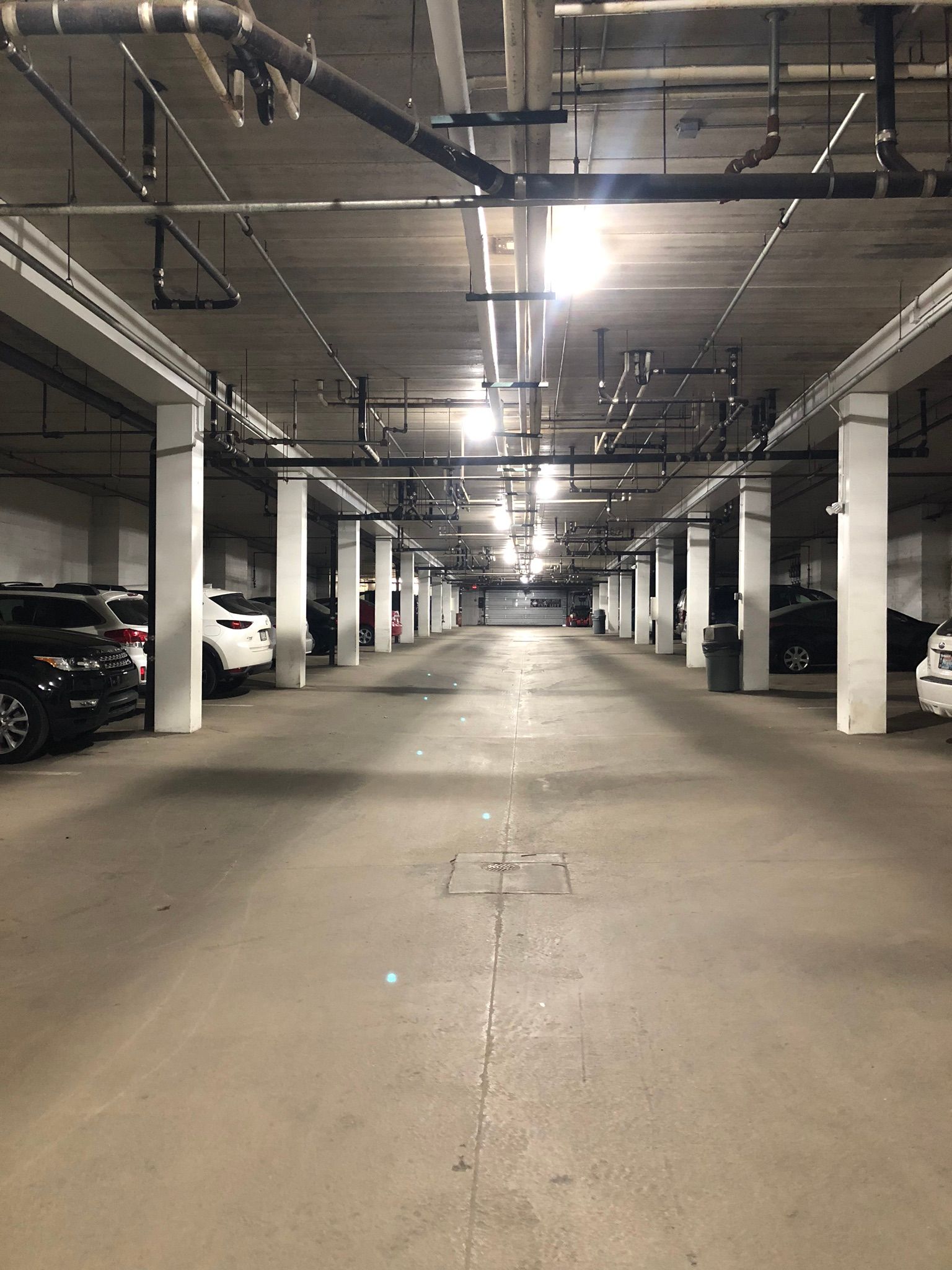 A parking garage with a lot of cars parked in it