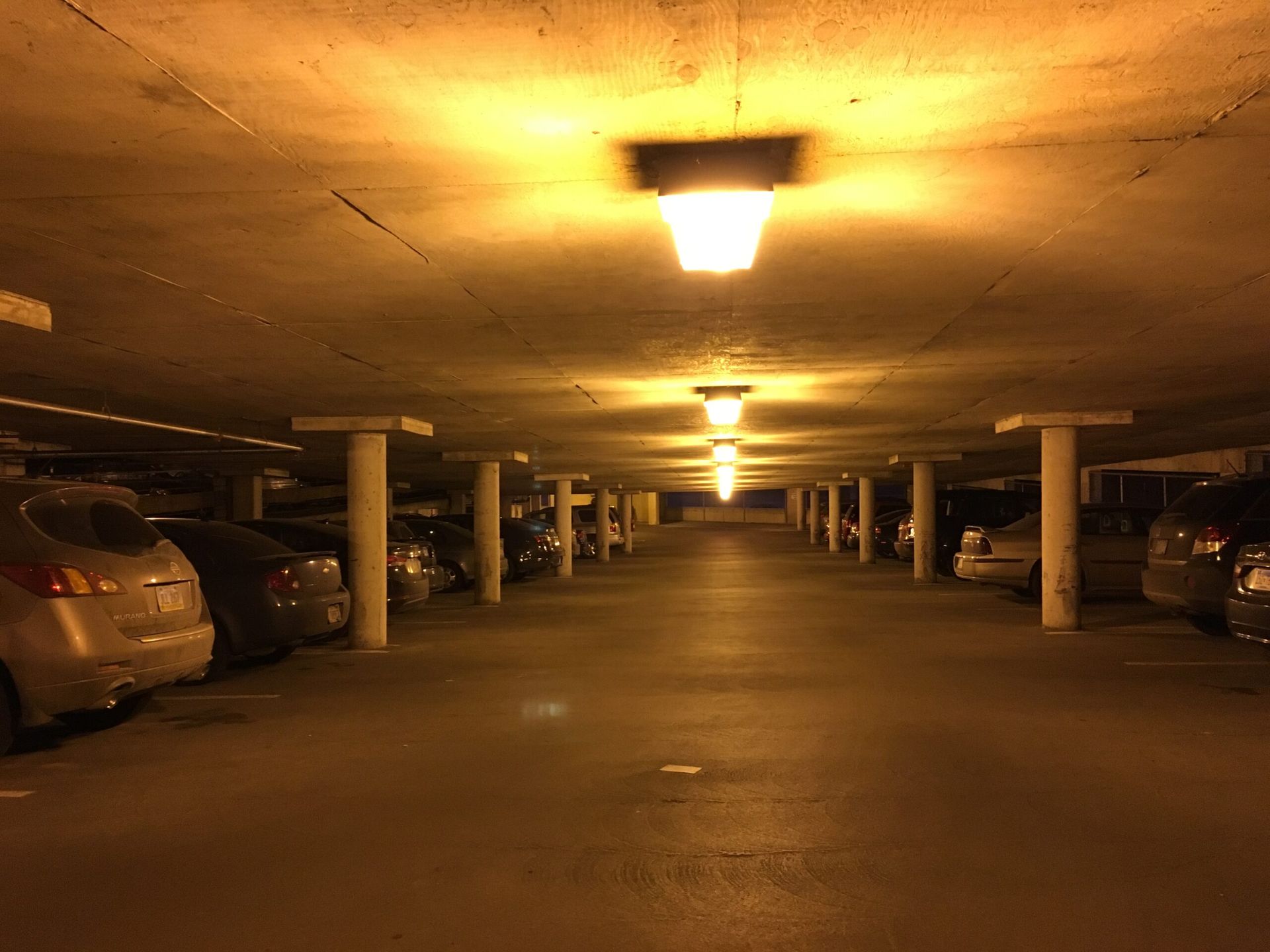 A lot of cars are parked in a parking garage