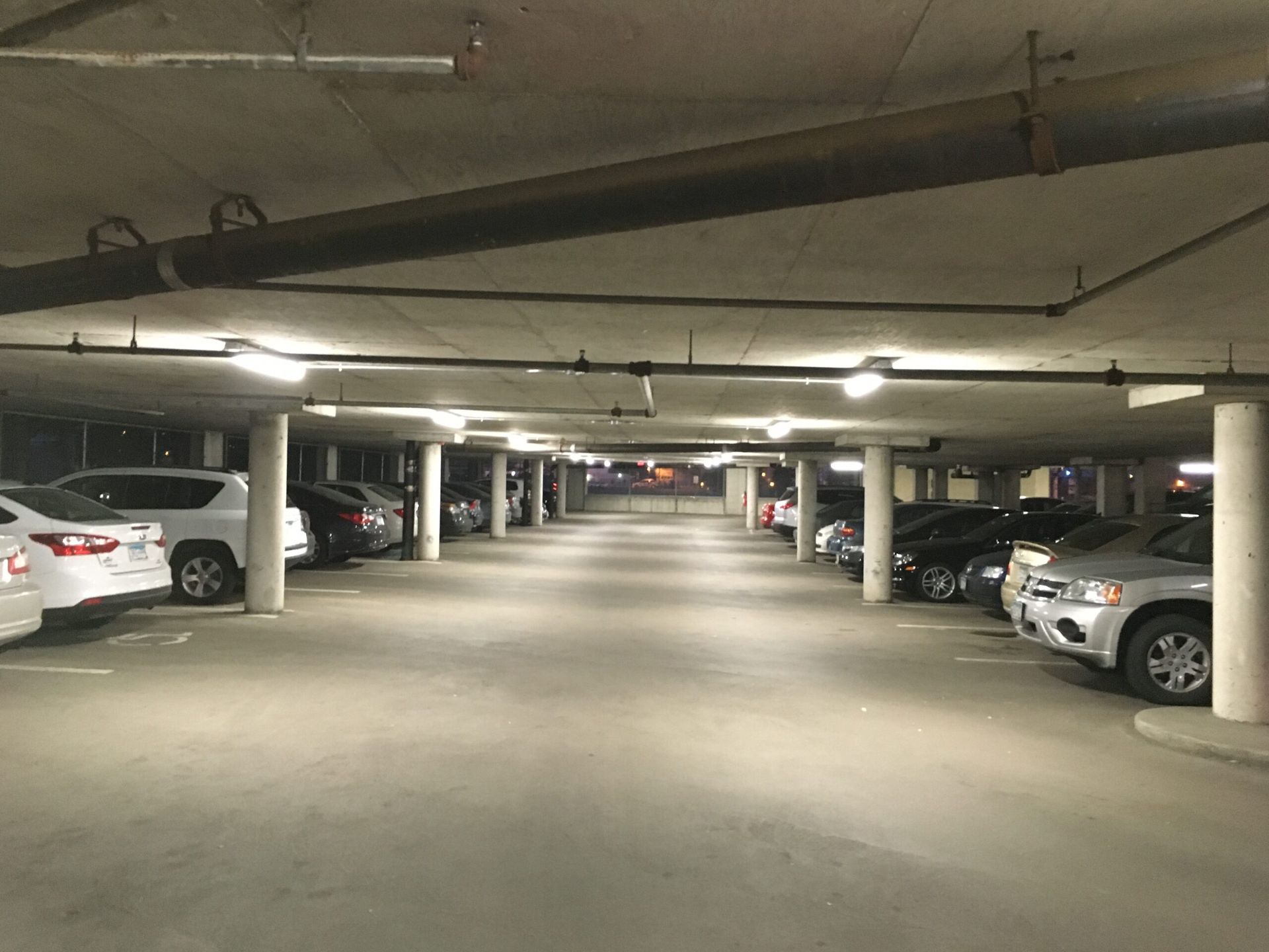 A lot of cars are parked in a parking garage