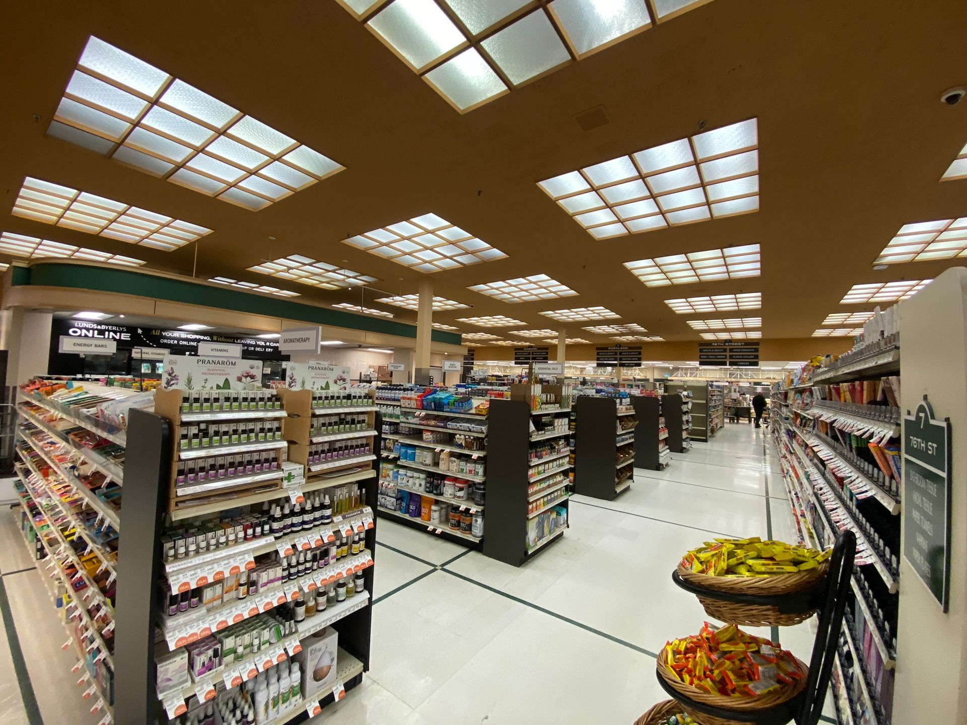 The inside of a grocery store with lots of shelves