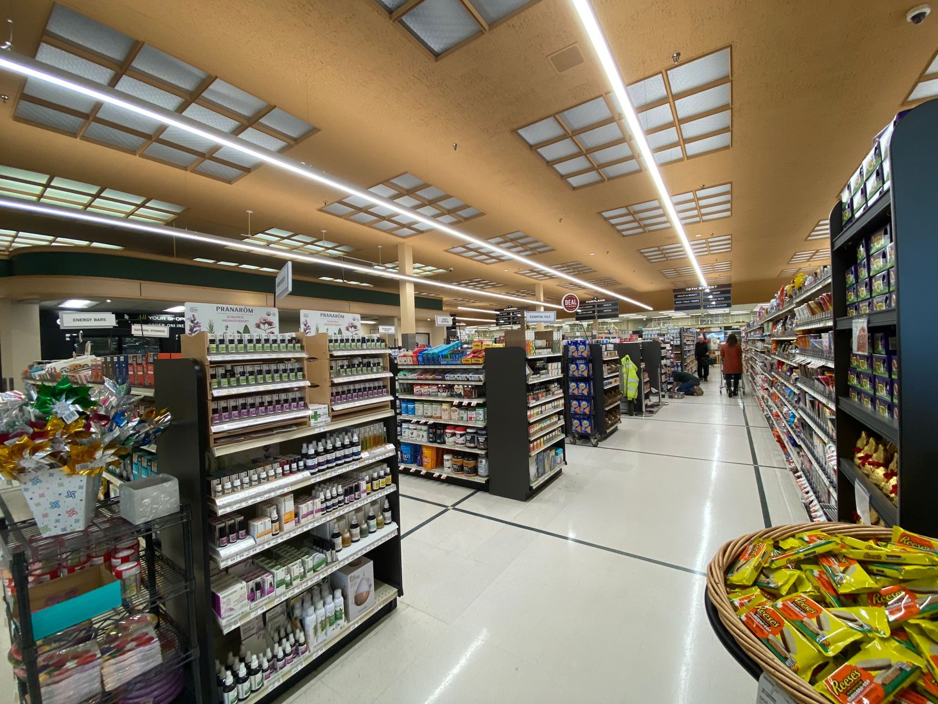 The inside of a grocery store filled with lots of shelves.