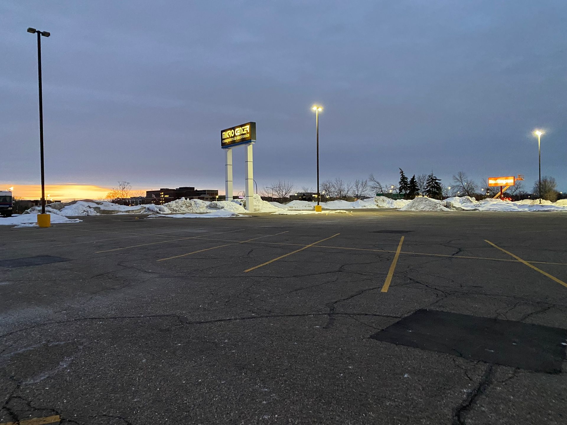 An empty parking lot with a sign that says 3.99 on it