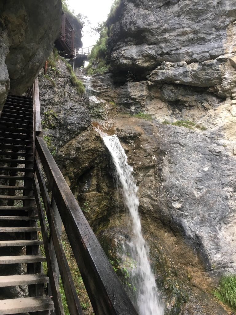 a wooden staircase leading up to a waterfall