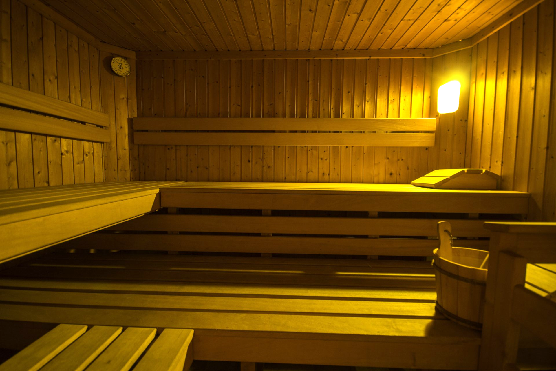 a wooden sauna with a bucket