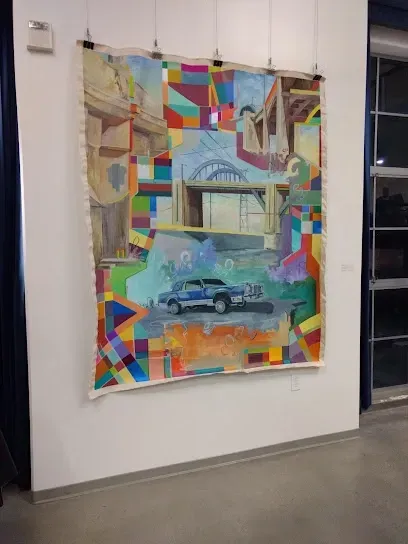 Tree Service El Monte Ca - A large, colorful artwork hangs on a white wall. It features a vintage car in the foreground, with abstract geometric shapes and a bridge in the background, conveying a dynamic, urban feel.