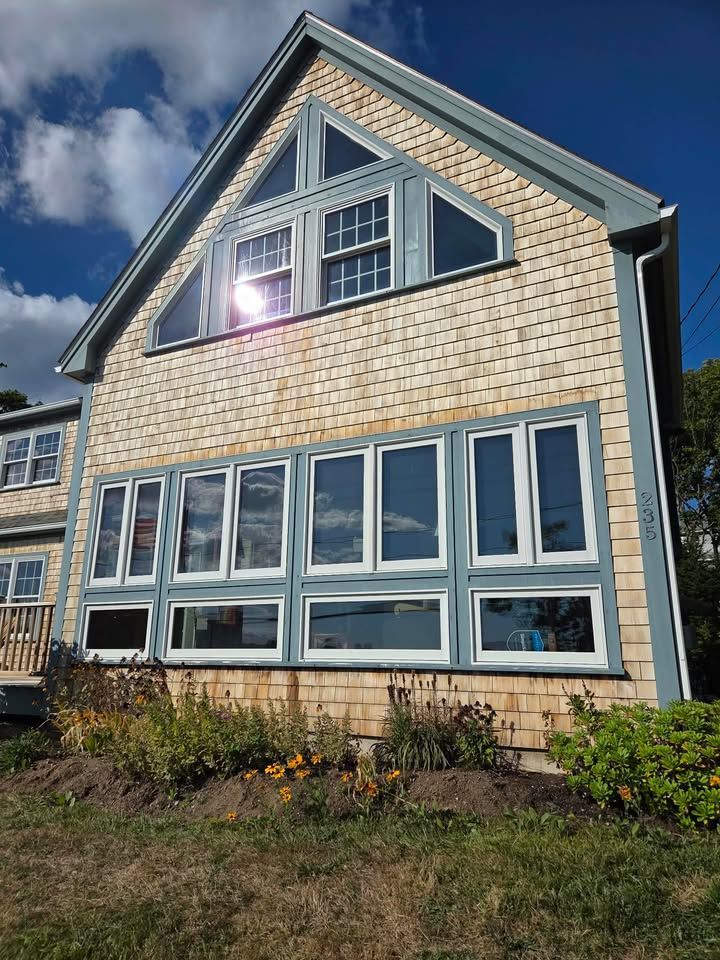 A pressure washer cleans dark, weathered wooden steps, revealing lighter, clean wood underneath over vibrant green grass. A pressure washer cleans dark, weathered wooden steps, revealing lighter, clean wood underneath over vibrant green grass.