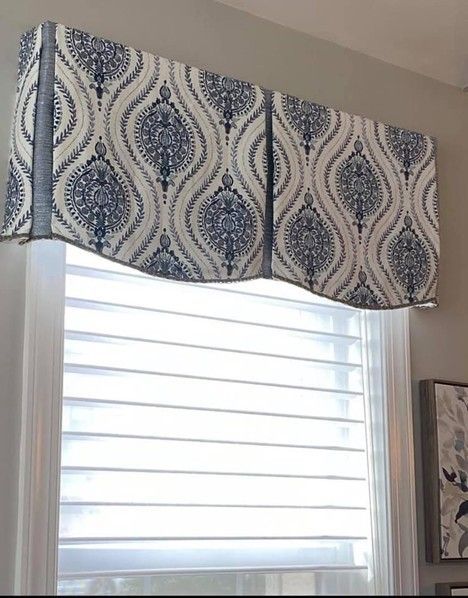 A pair of gold curtains are hanging on a window.