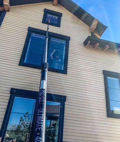 A person is cleaning the windows of a house.