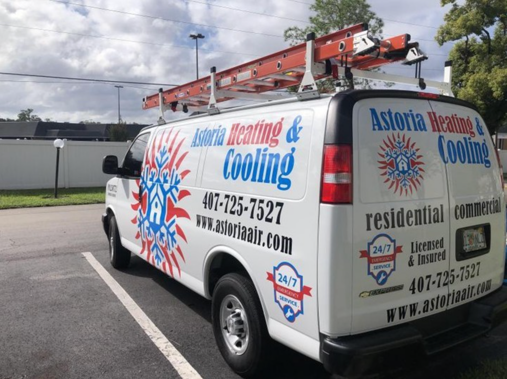 a white astoria heating and cooling van is parked in a parking lot .