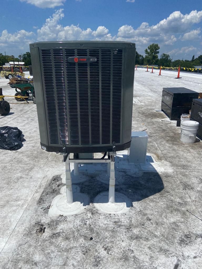 a large air conditioner is sitting on top of a roof .