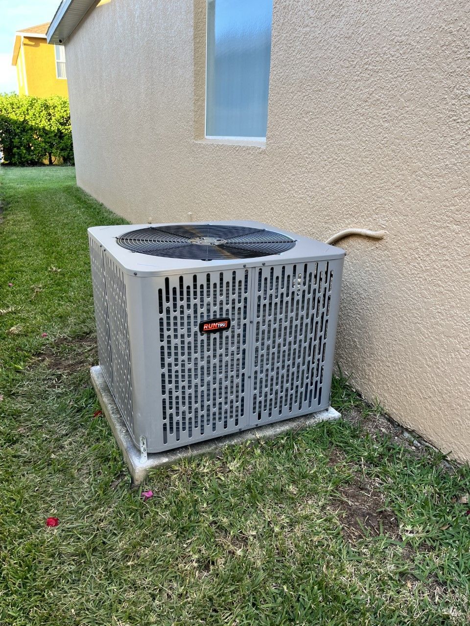 a large air conditioner is sitting on the side of a house .
