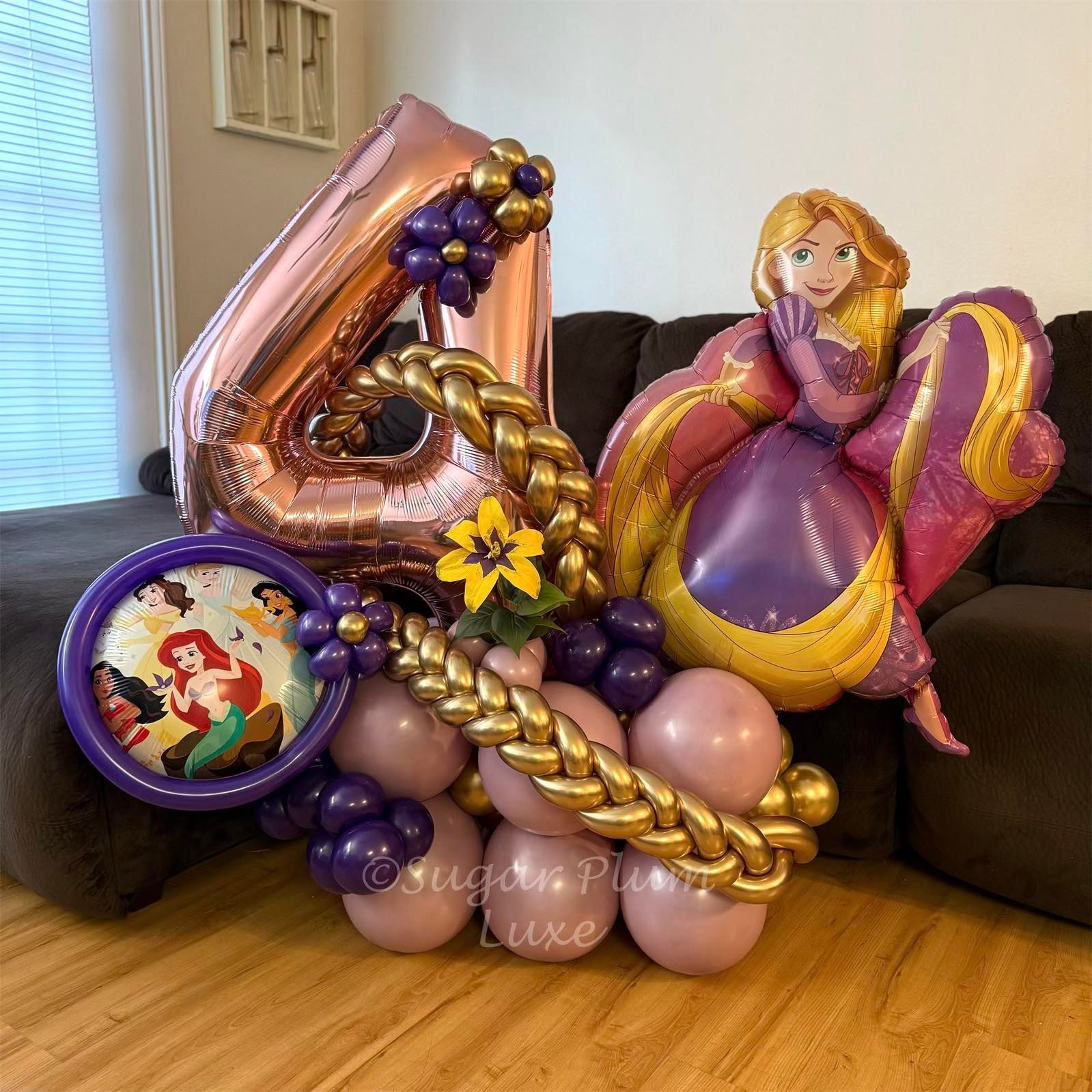 Purple and gold balloon arrangement with a large 4 and princess-themed accents on a couch