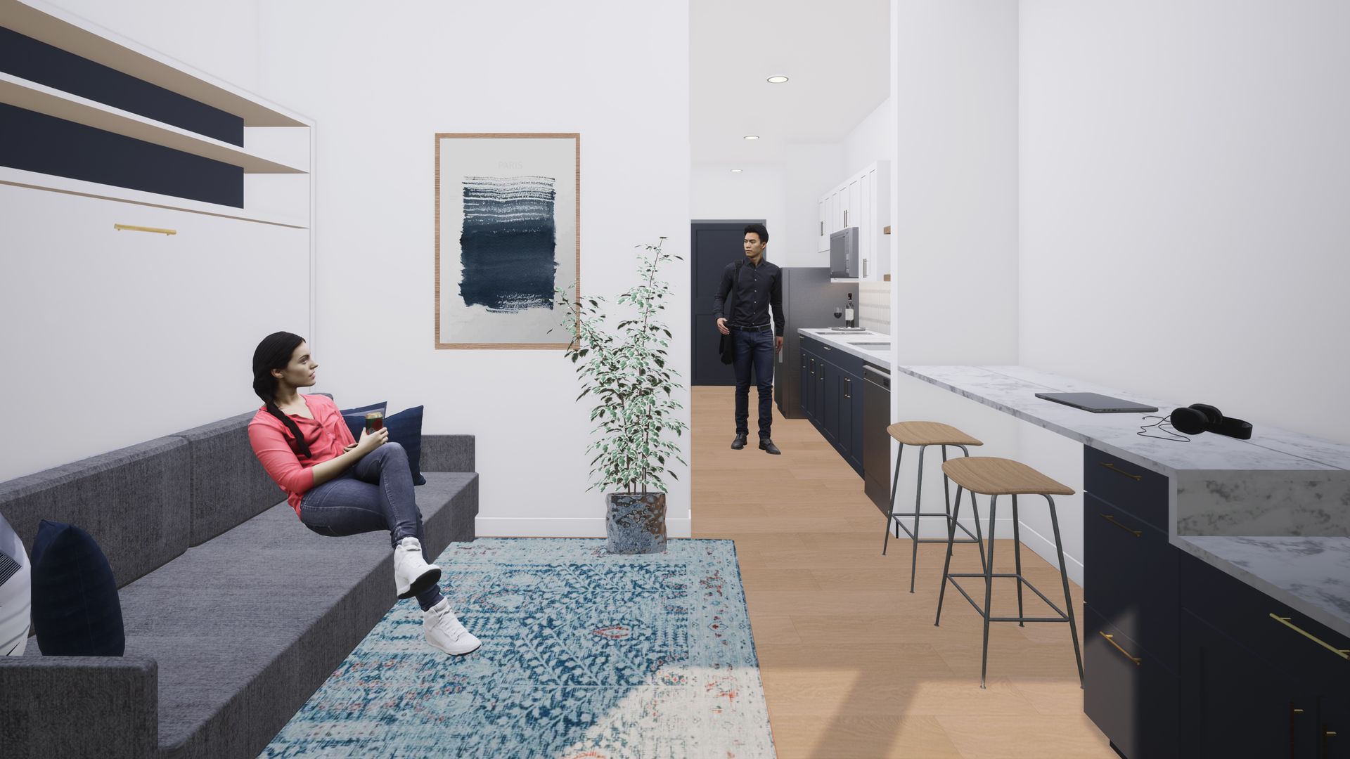 Interior view: Woman on a couch, man in the kitchen area. Modern decor, open floor plan.