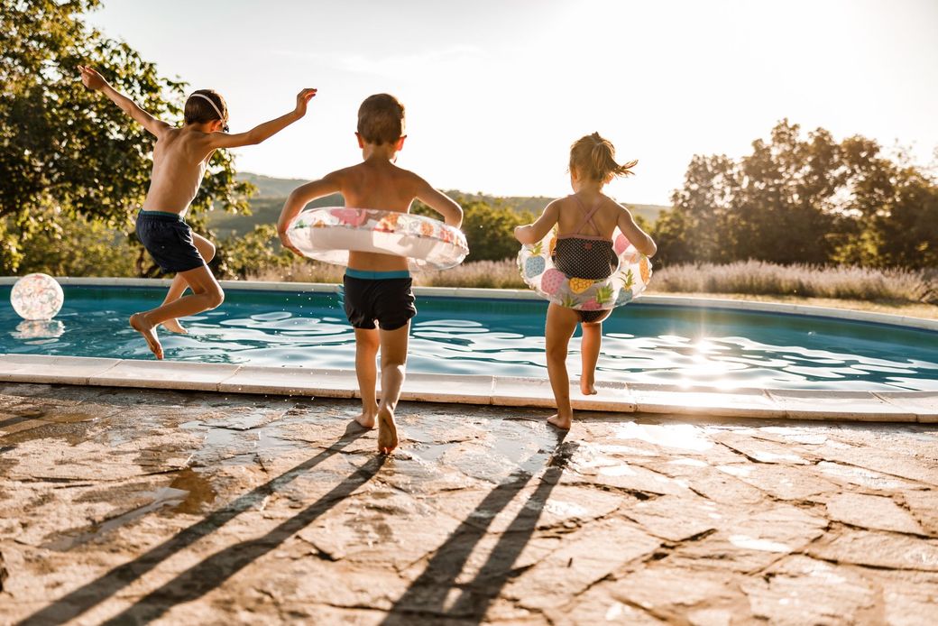 People jumping into a pool