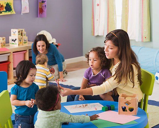 Teachers and toddlers in daycare - Child Care Center Lowell, MA