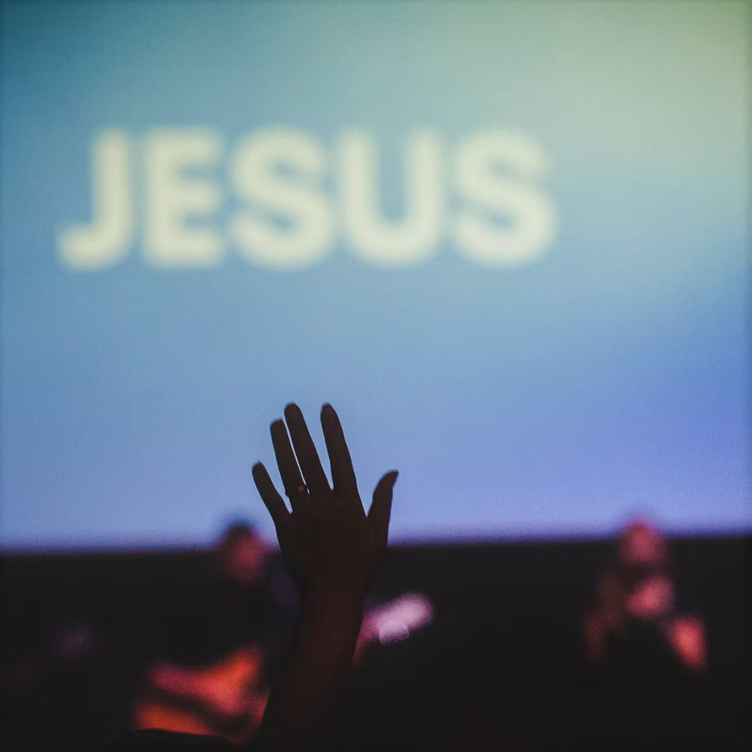 Hand raised toward blurred 