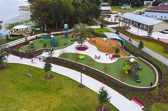 An Aerial View Of A Park With A Playground And A Lake - Circle Dunnellon, FL - Rainbow Springs Realty Group