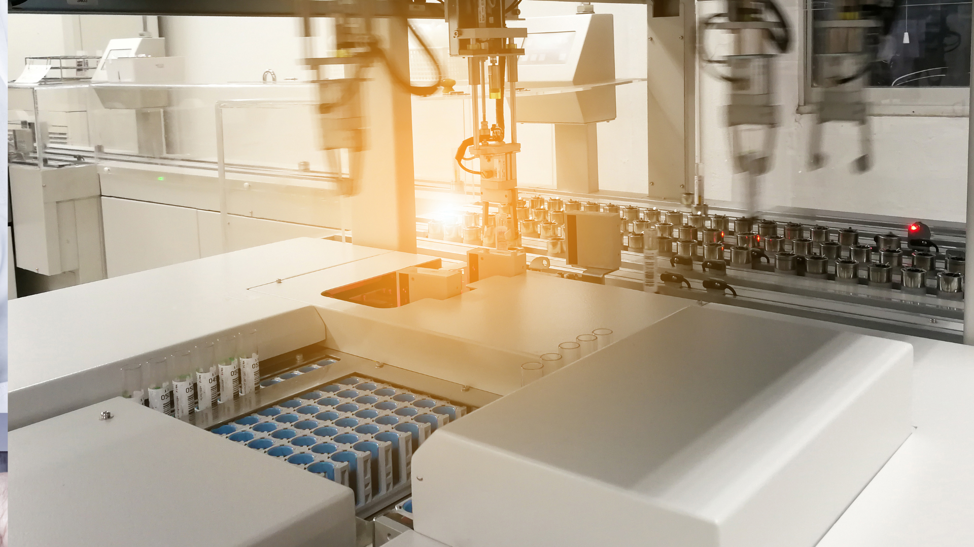 Industrial robotic arm assembling components on an automated production line in a bright factory