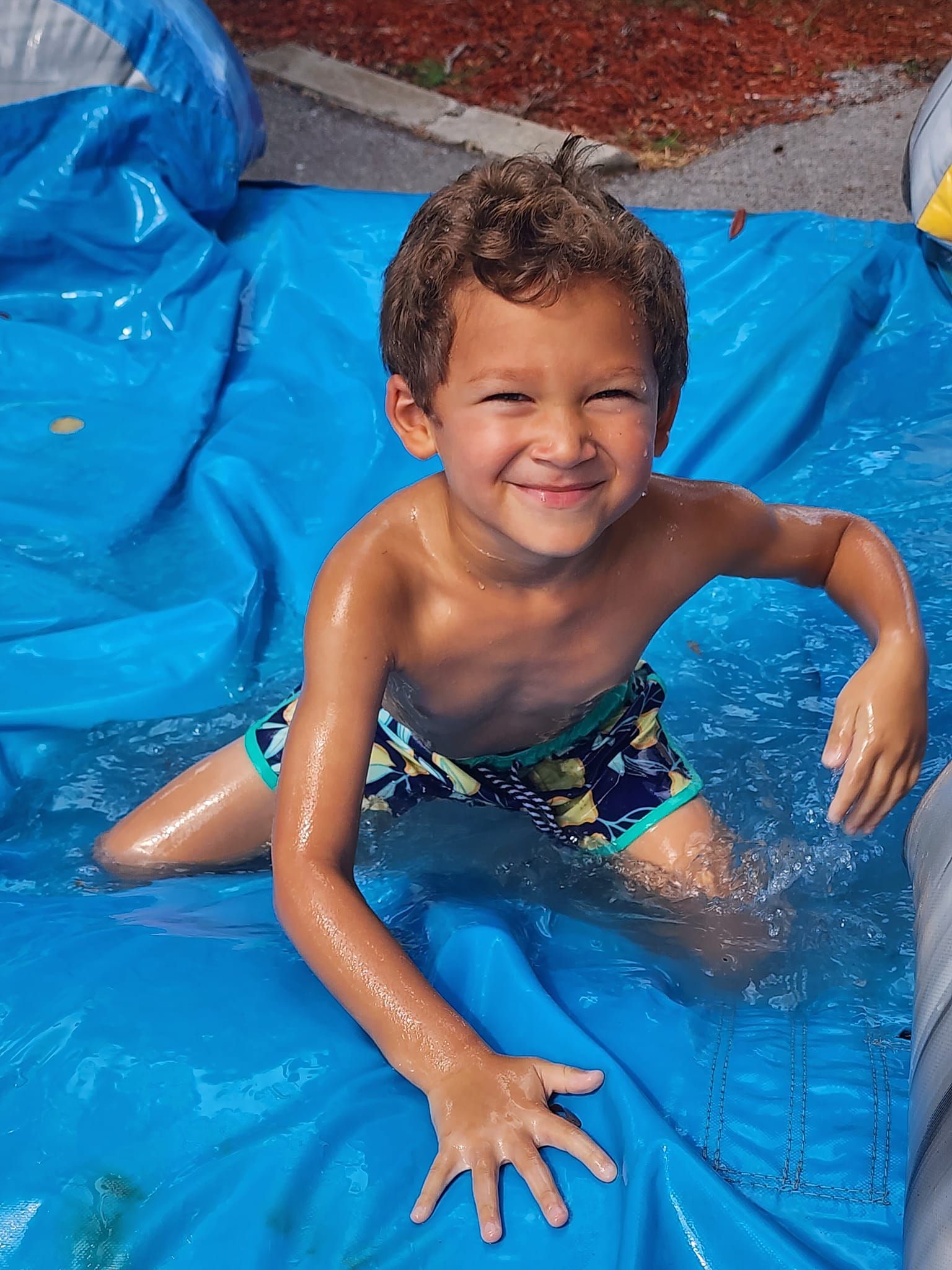 toddler playing in a waterslide at daycare