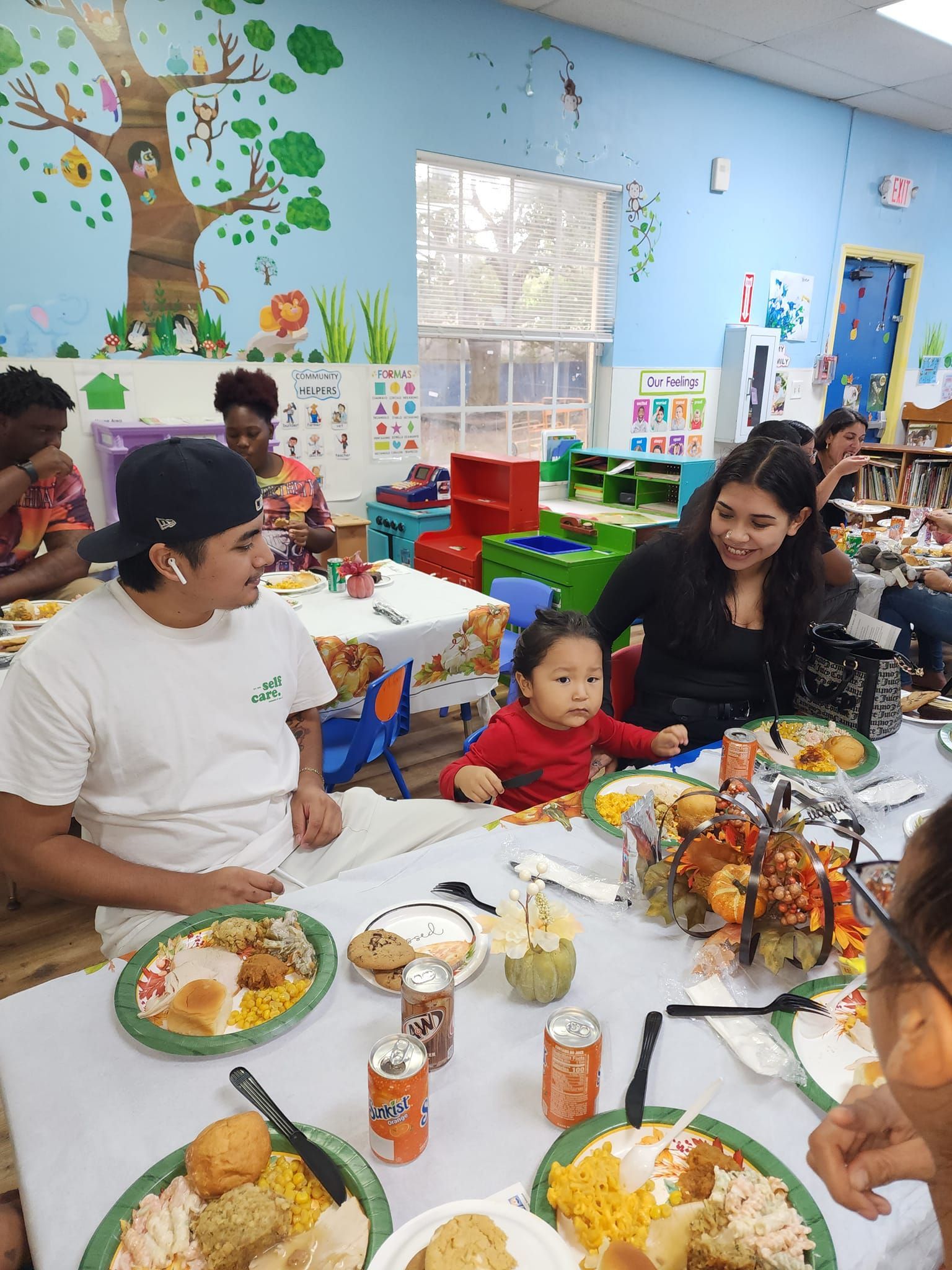 A group of people are sitting at a table with plates of food.