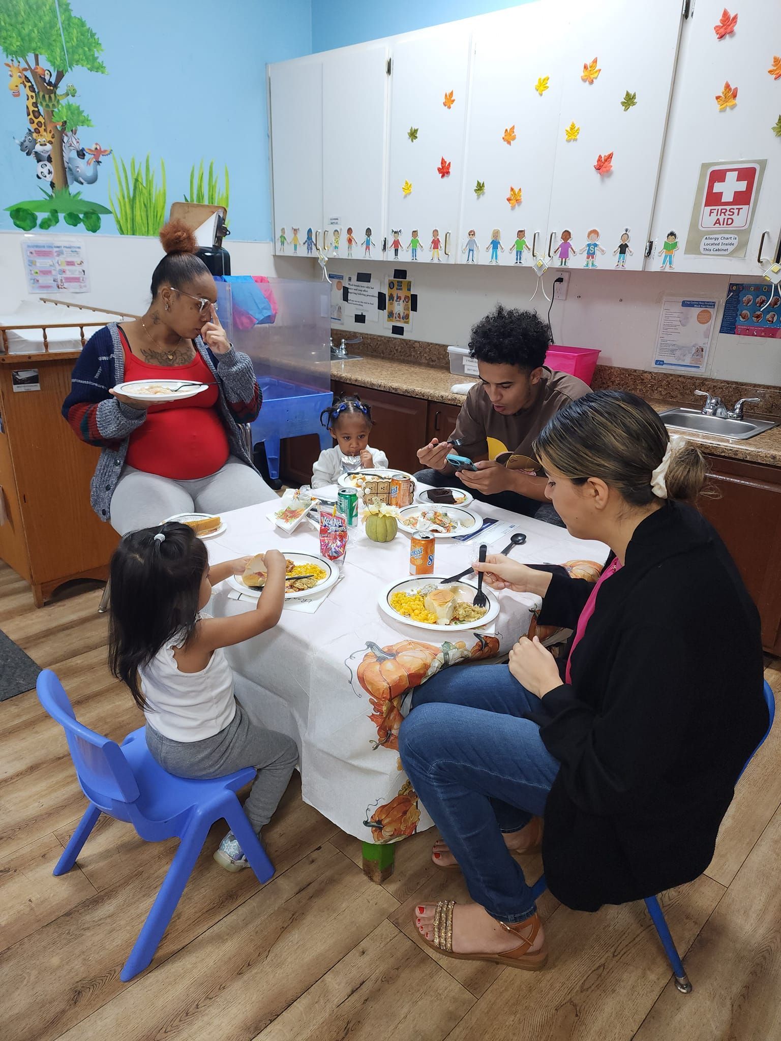 A group of people are sitting around a table eating food.