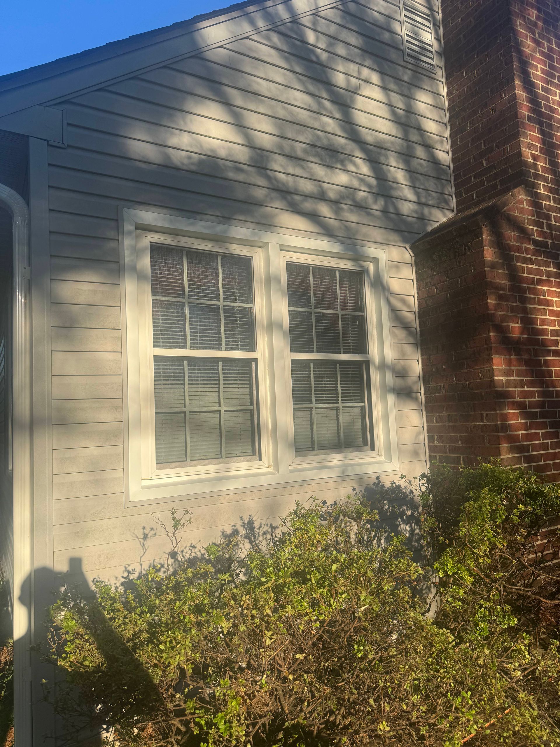 Damaged asphalt shingle roof, with missing and damaged shingles, chalk markings.