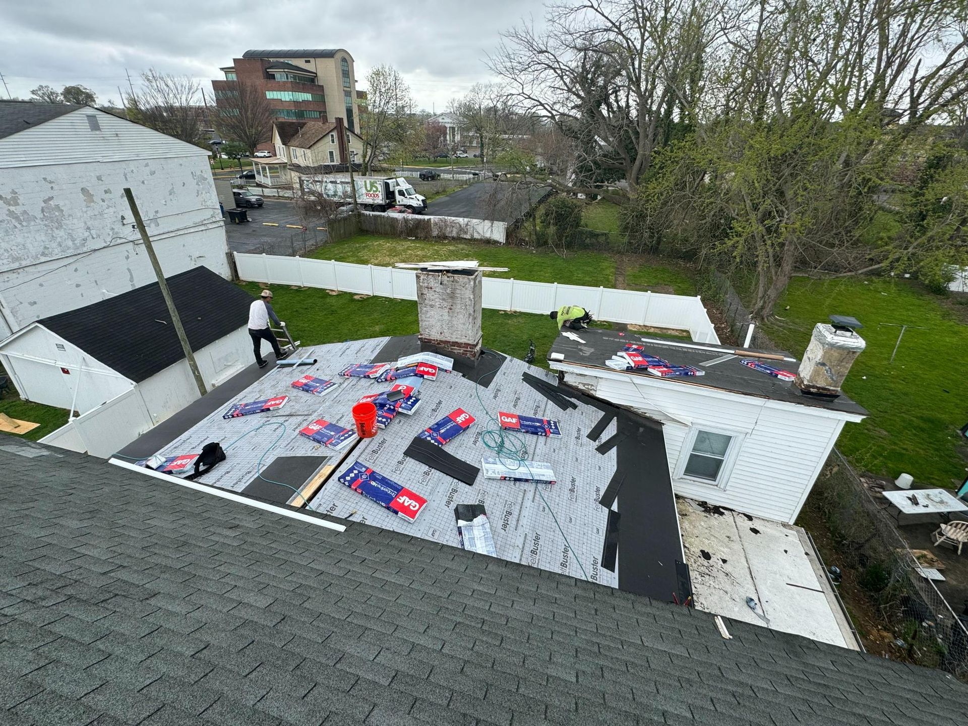 An aerial view of a roof being installed on a house.