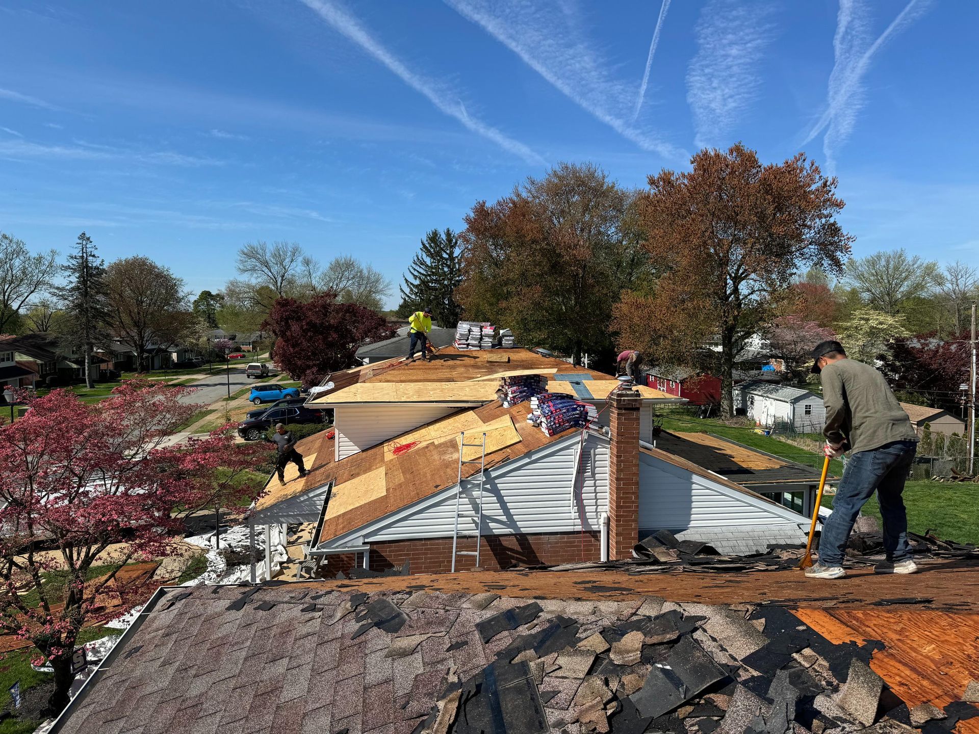 A man is working on the roof of a house.