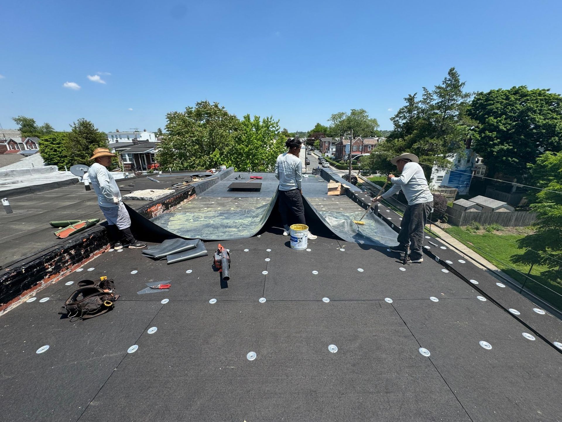 A group of people are working on a roof.