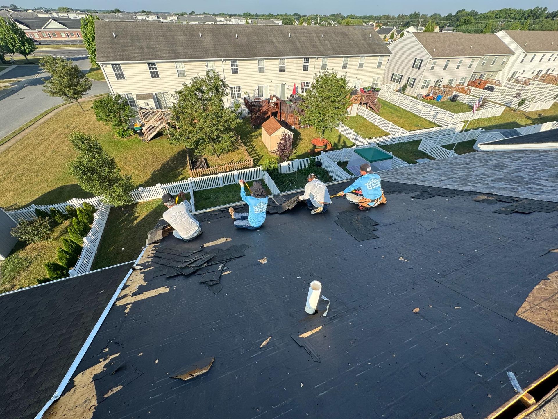 A group of people are working on a roof.