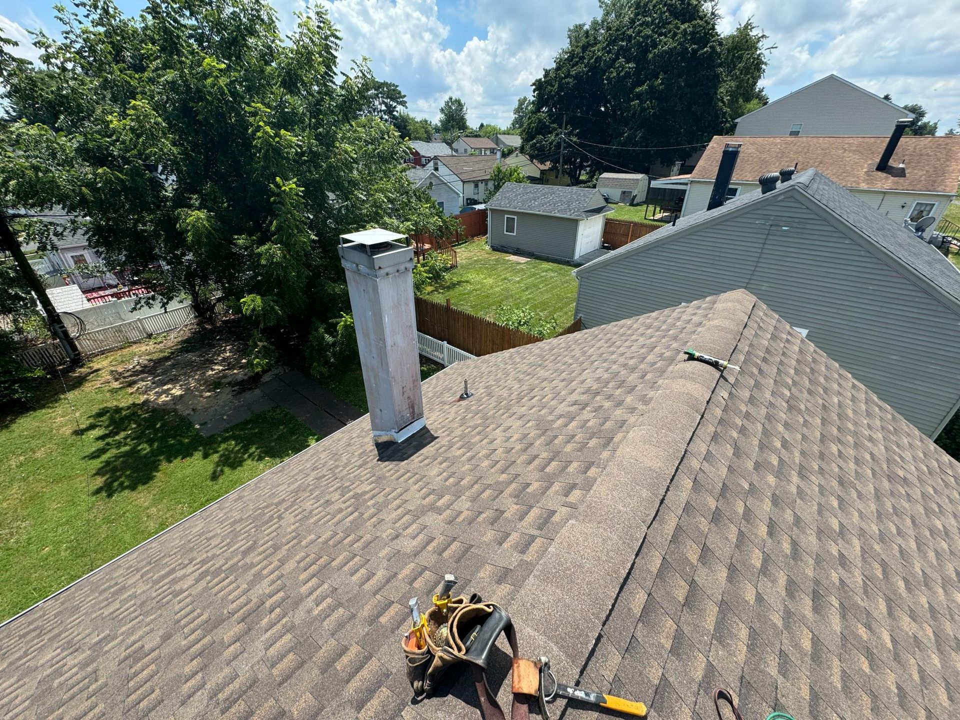 An aerial view of a roof with a chimney and tools on it.