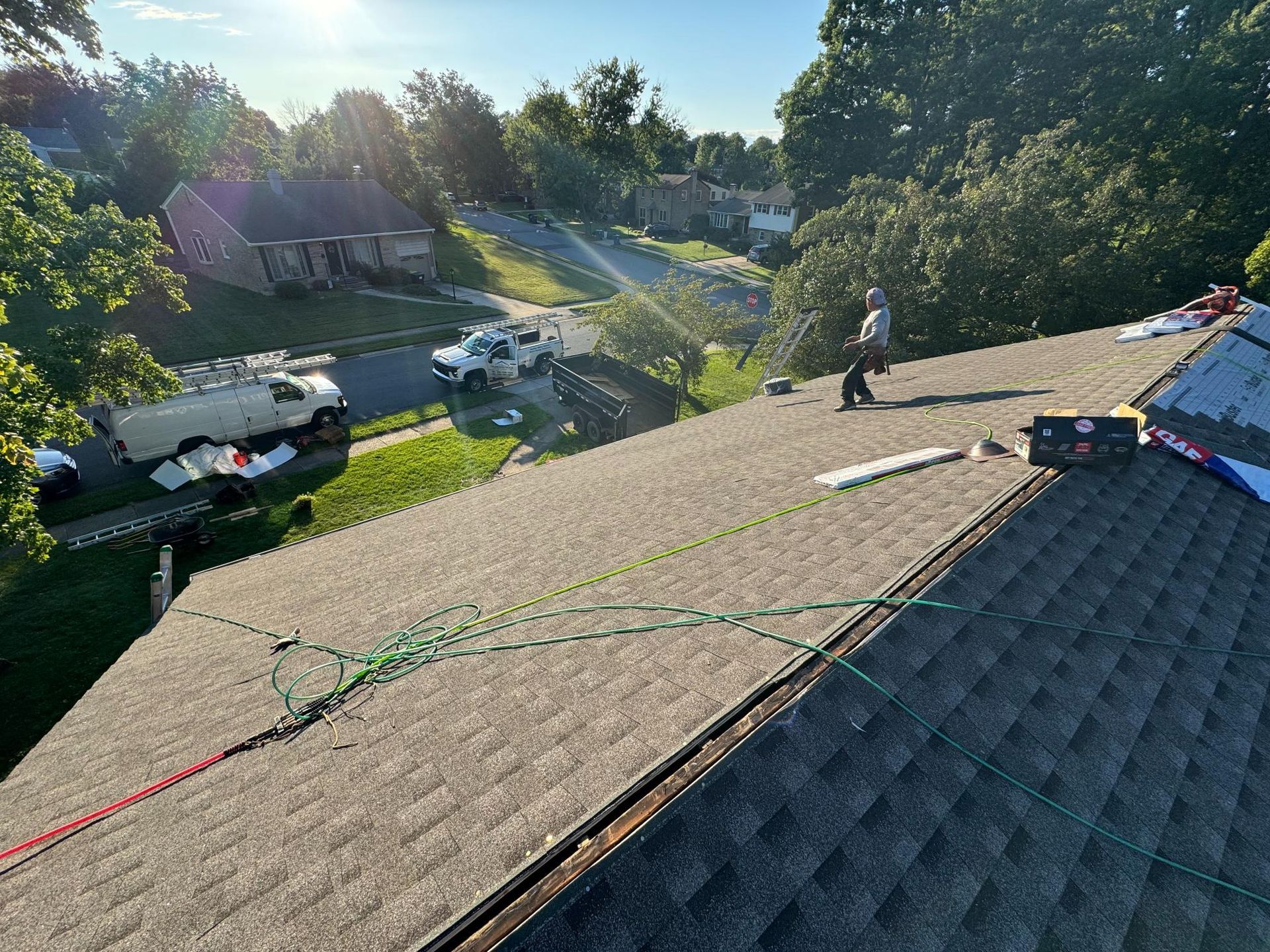 A man is working on the roof of a house.