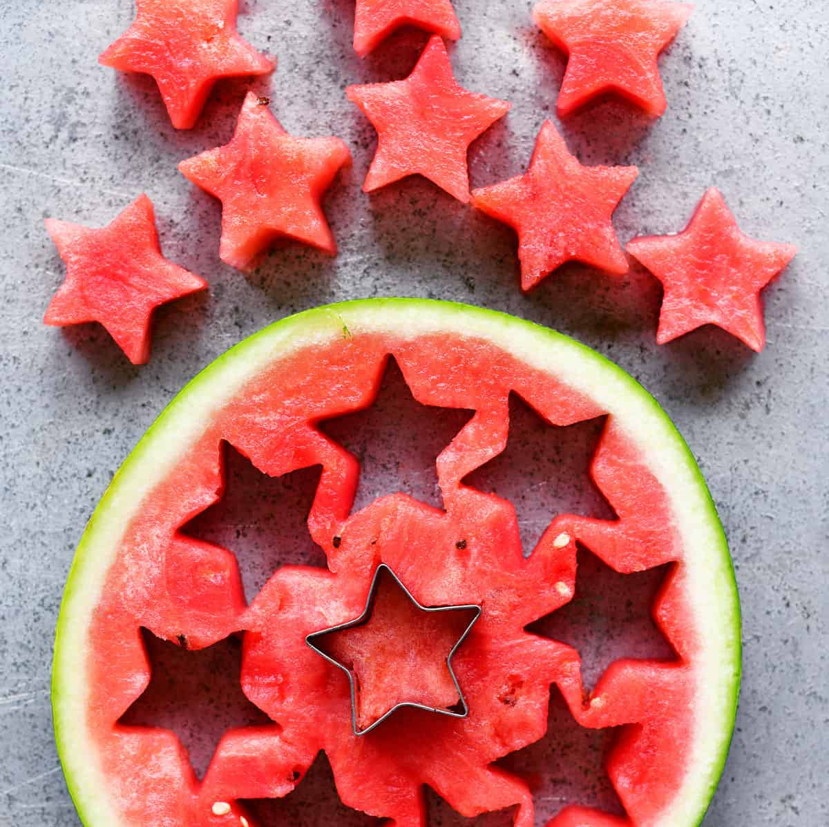 cutting out watermelon pieces with star cookie cutter