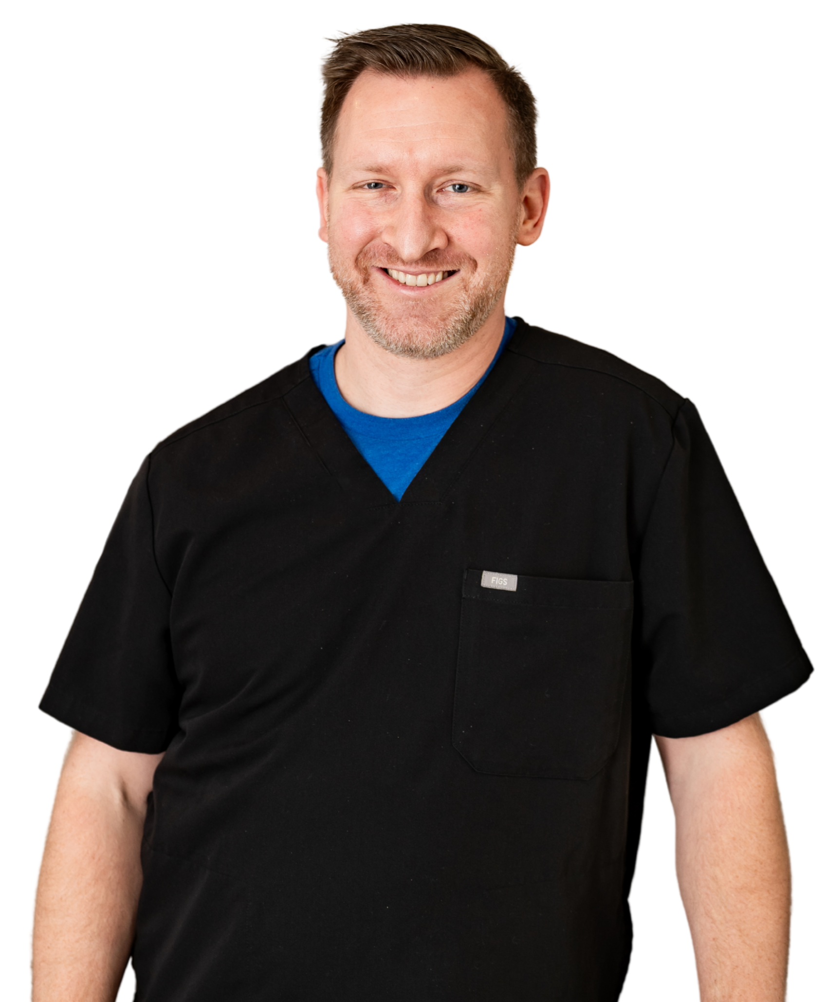 A smiling person wearing a black scrub top over a blue undershirt against a white background.