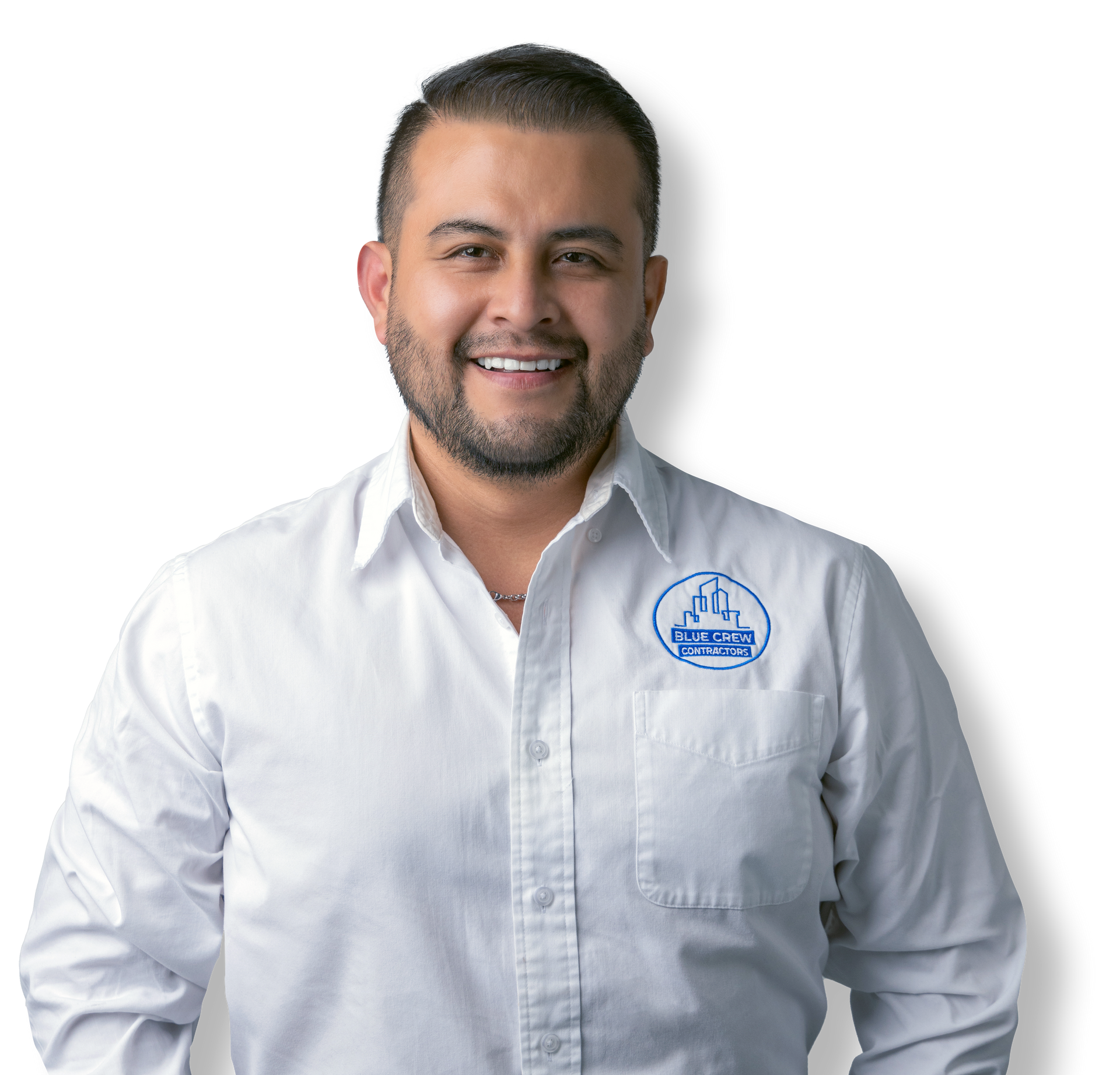 A man wearing a white shirt with a blue logo on his chest