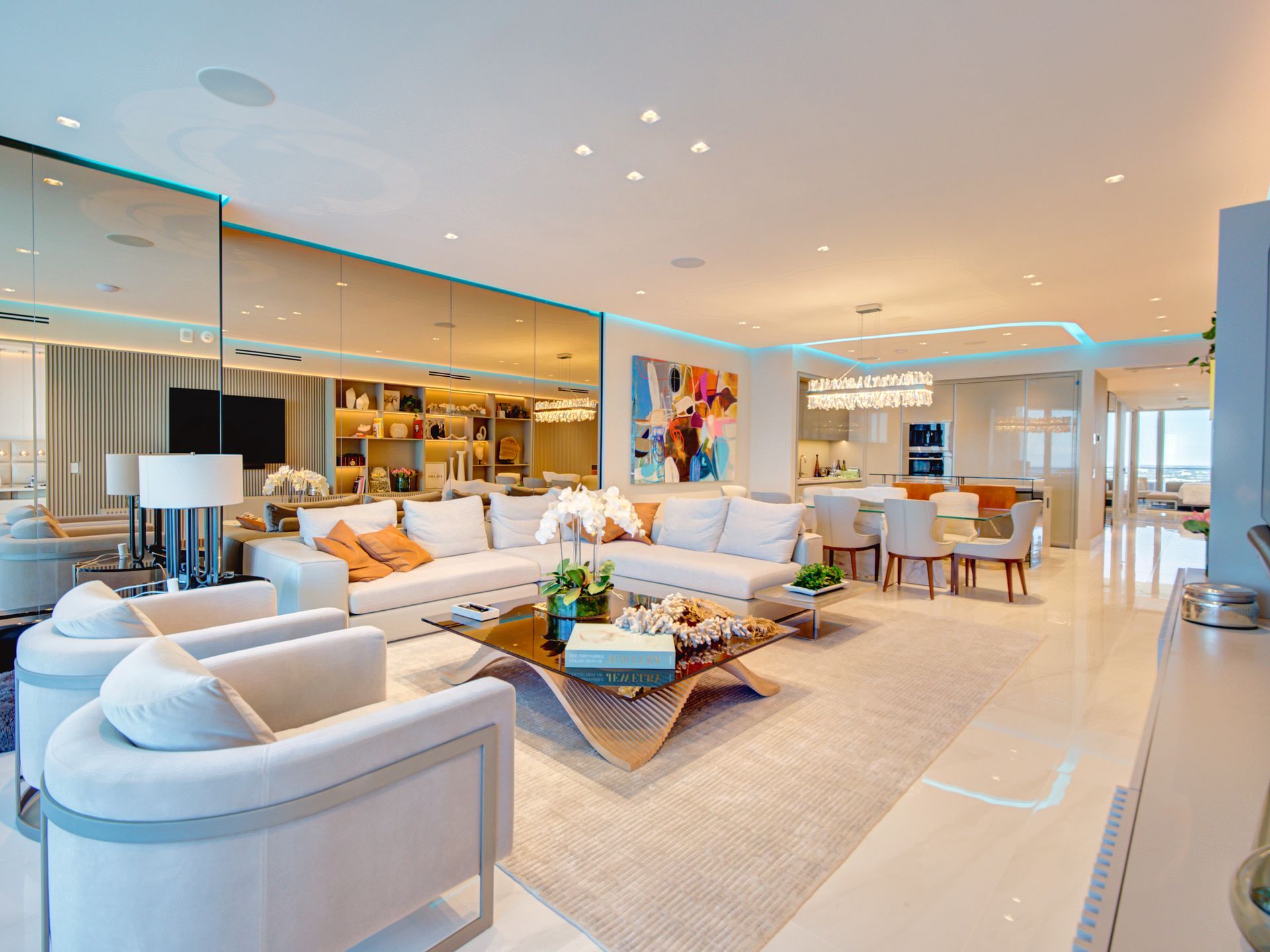 A living room with a couch , chairs , and a coffee table.