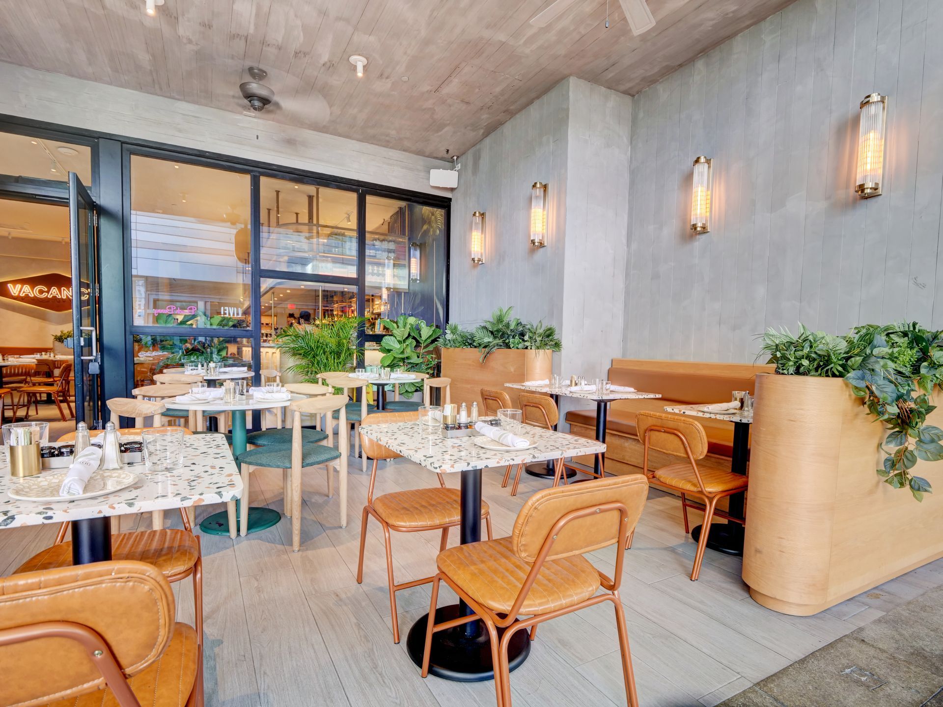 There are many tables and chairs in the restaurant.