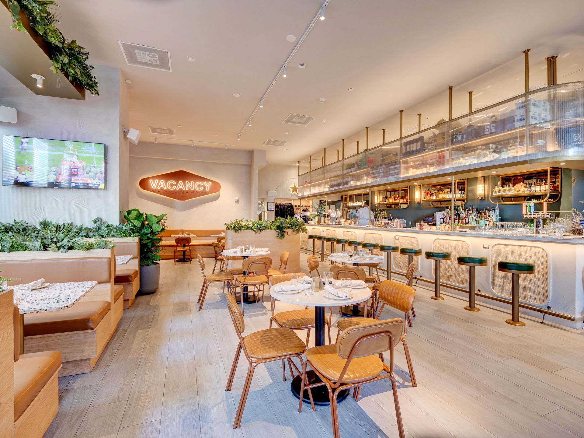 A restaurant with tables and chairs and a sign that says bacardi