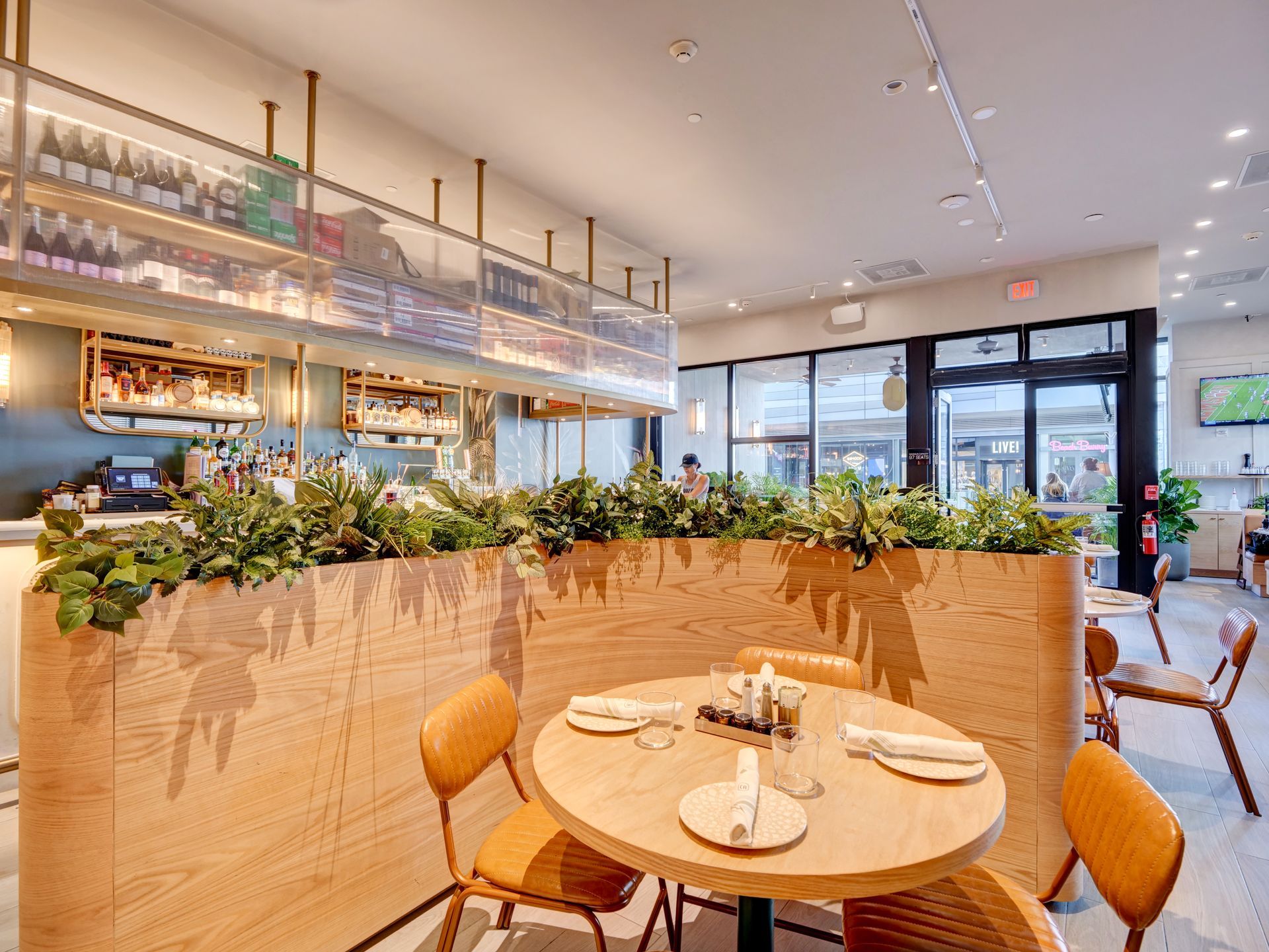 A restaurant with tables and chairs and a wooden divider.