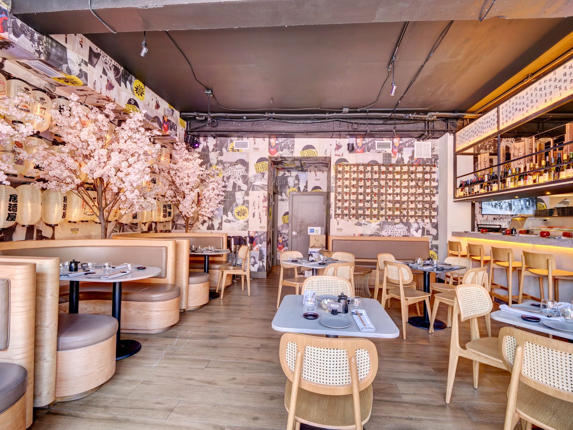 A restaurant with tables and chairs and a bar.