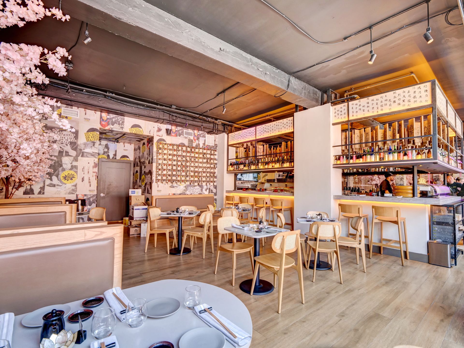 A restaurant with tables and chairs and a bar.