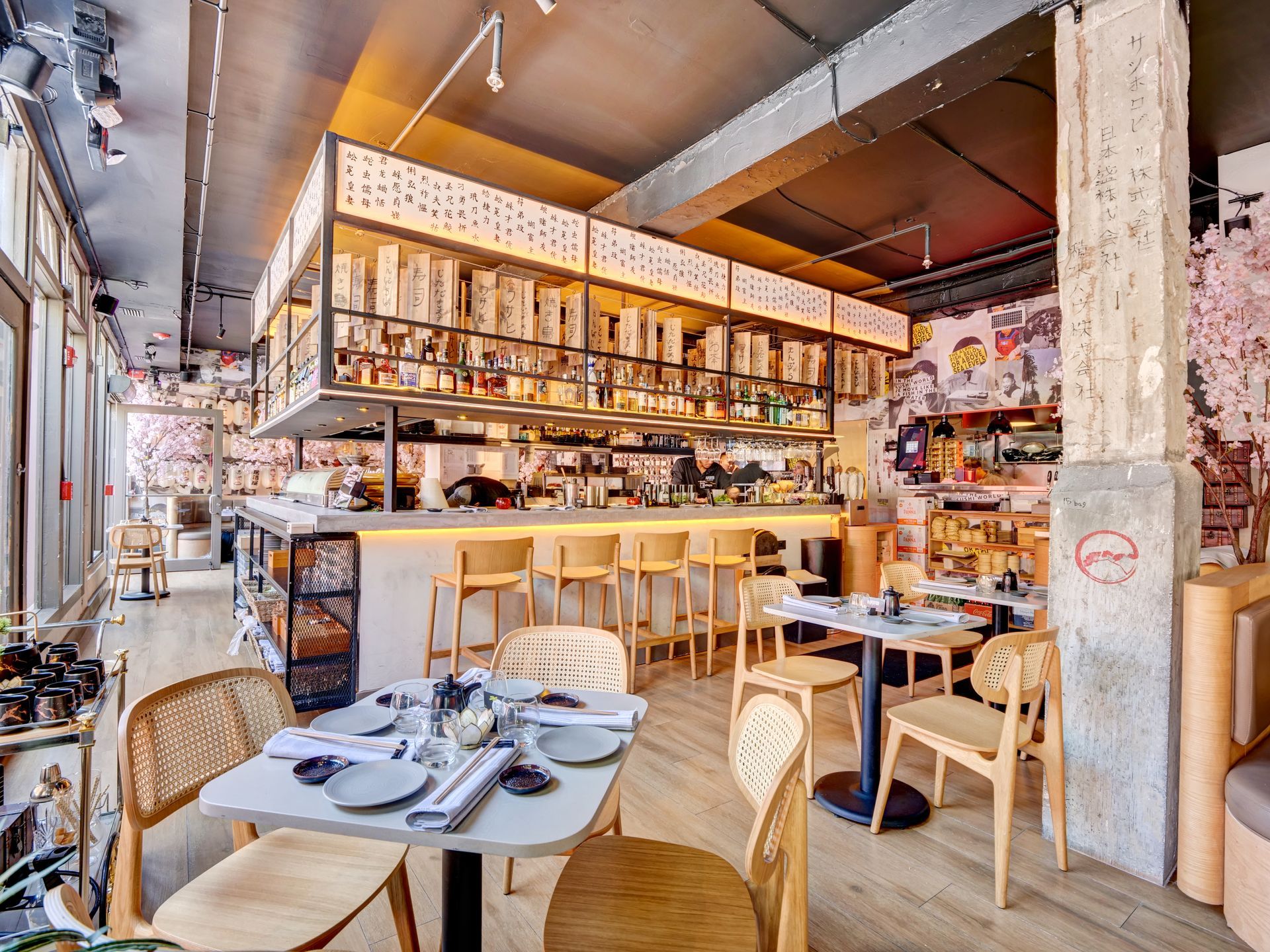 A restaurant with tables and chairs and a bar.