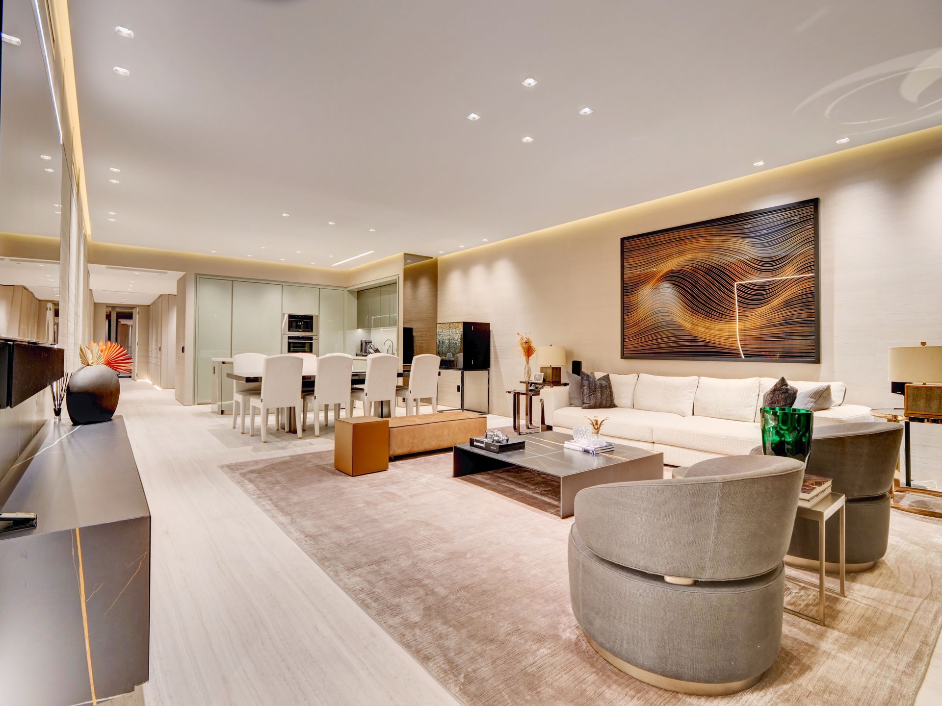 A living room with a couch , chairs and a table