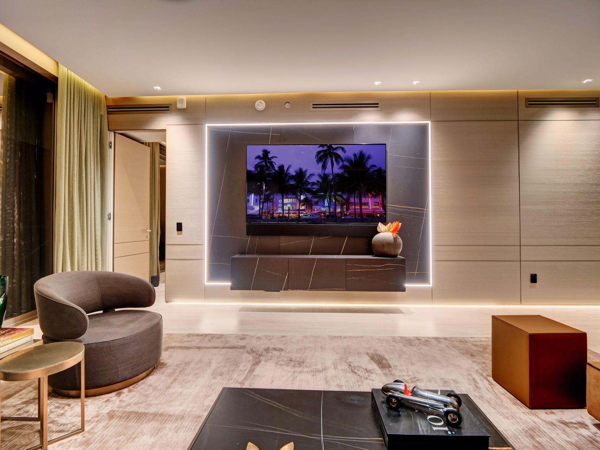 A living room with a large flat screen tv on the wall