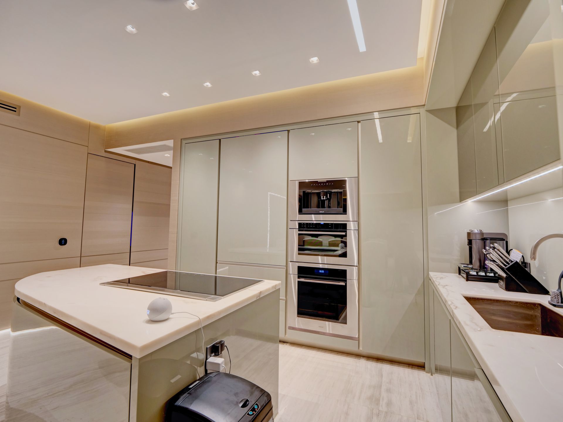A kitchen with white cabinets and stainless steel appliances