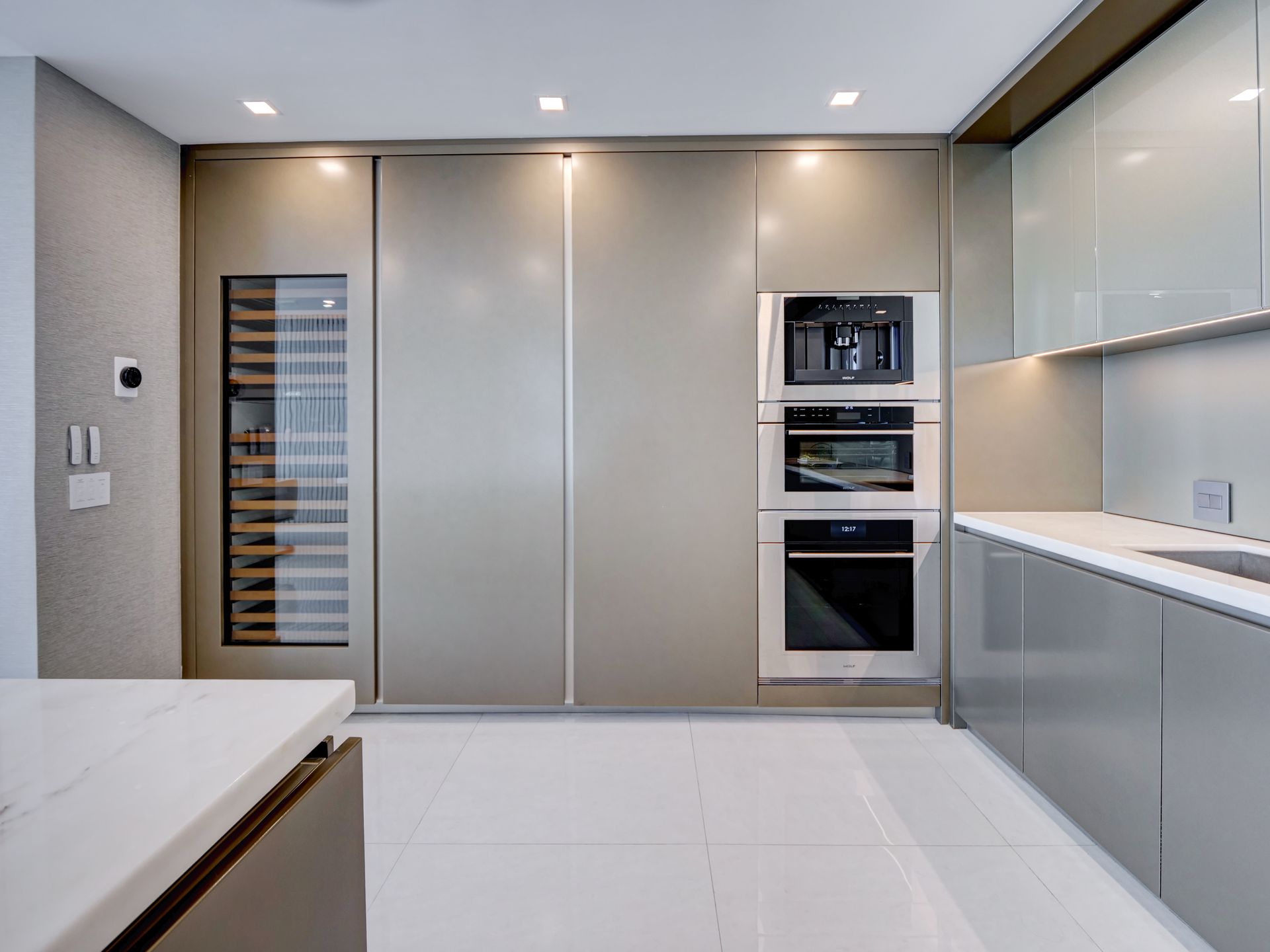 A kitchen with stainless steel appliances and a wine cooler